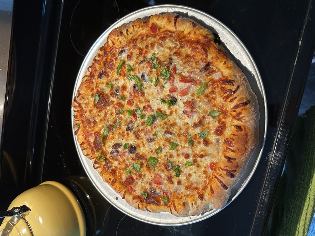 Homemade pizza with melted cheese and fresh toppings